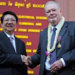 Cambodian deputy Prime Minister Sok An (L) shakes hands with British Khmer art collector Douglas Latchford (R) during a function at the National Museum of Cambodia in Phnom Penh on June 12, 2009. Latchford, a well known collector of Khmer art repatriated a number of Khmer antiquities during the event. AFP PHOTO/TANG CHHIN SOTHY (Photo credit should read TANG CHHIN SOTHY/AFP via Getty Images)