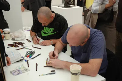Jake and Dinos Chapman making Currency Project, 2007, at Frieze London.
