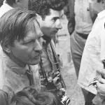American film director Stan Vanderbeek (1927 - 1984) (left) talks with attendees as he hosts a visit to his studio and 