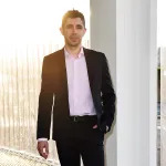 A smiling man in a suit.