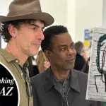 A Caucasian man in a hat and a Black man look ar a painting. Inset is an image of a bald Black man with the text 