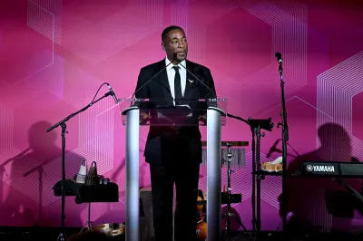 A Black man standing at a podium.
