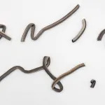 Ceramic sculptures that look abstract but forms in Gregg shorthand.