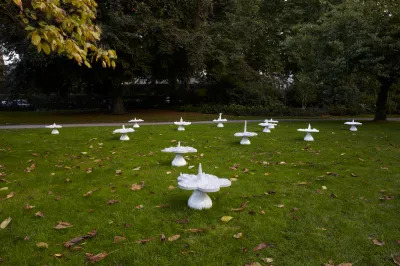 A group of flower-shaped sculptures in a park.