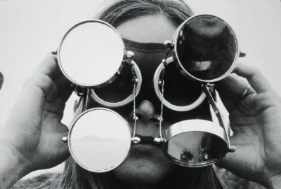 A woman with a glasses-like device strapped to her head.