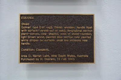 A sculpture resembling a museum wall text cast in bronze.