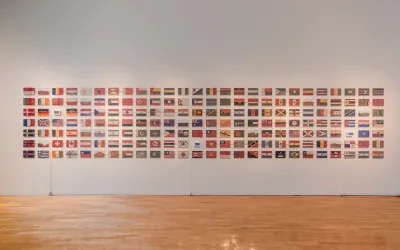 A group of flags remade in colored sand.