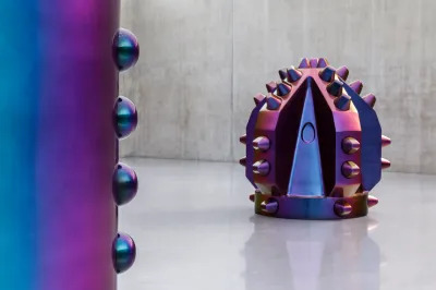 A purple sculpture resembling an enlarged drill head.