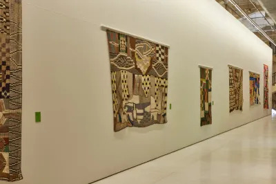 A group of wall-hung weavings.