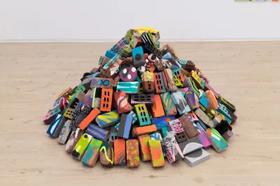 A sculpture made of a collection of painted bricks. 