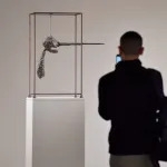 A person walks past Alberto Giacometti