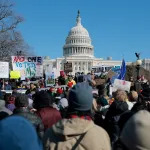 A group of people protesting in front of the White House.