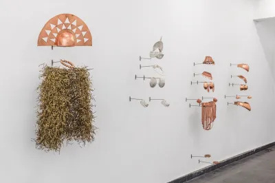 Several artworks resembling costumes whose armor-like parts are made of copper.