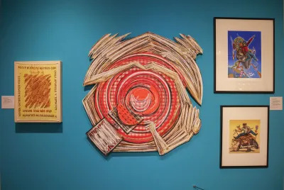 View of a museum exhibition with an work of a swirling kitchen table.
