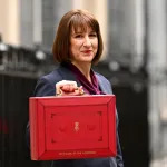 LONDON, ENGLAND - OCTOBER 30: Chancellor of the Exchequer, Rachel Reeves, poses with the red Budget Box as she leaves 11 Downing Street to present the government