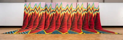 A long weaving resembling a colorful mountain range.