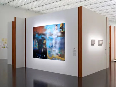 Installation view of a museum exhibition showing a painting with a man meeting Anubis and Osiris. 