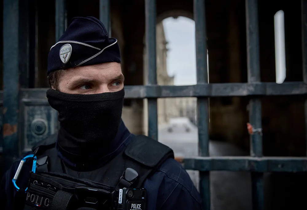 French Police officers seal off the entrance to the Louvre Museum in Paris after a jewel heist on October 19, 2025.