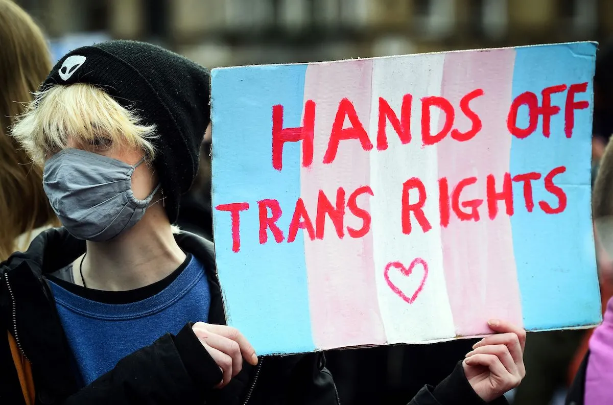A person holding a sign that says