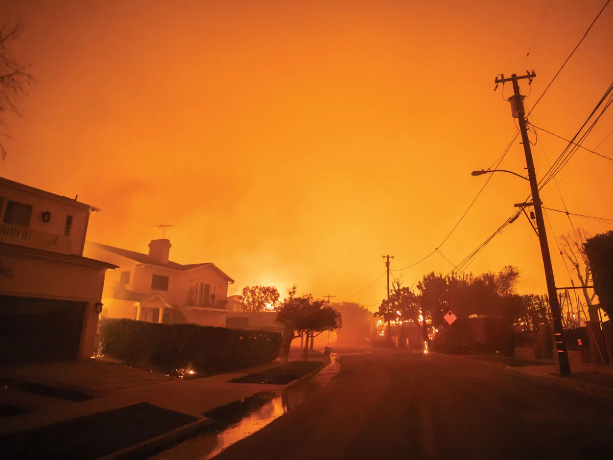 LOS ANGELES, CALIFORNIA - JANUARY 8: View of Radcliffe avenue as the Palisades Fire burns in during a powerful windstorm on January 8, 2025 in the Pacific Palisades neighborhood of Los Angeles, California. The fast-moving wildfire is threatening homes in the coastal neighborhood amid intense Santa Ana Winds and dry conditions in Southern California. (Photo by Apu Gomes/Getty Images)
